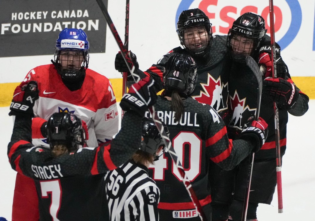 Canada's Jocelyne Larocque celebrates her goal against Czechia with teammates Laura Stacey, Blayre Turnbull and Emily Clark during first period semifinal hockey action at the IIHF Women's World Hockey Championship in Utica, N.Y., Saturday, April 13, 2024.