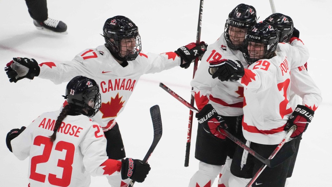 Canada's Erin Ambrose celebrates her goal over United States with teammates during first period gold medal hockey action at the IIHF Women's World Hockey Championship in Utica, N.Y., Sunday, April 14, 2024.