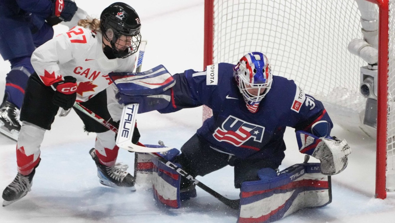 United States goaltender Aerin Frankel makes a save on Canada's Emma Maltais during first period gold medal hockey action at the IIHF Women's World Hockey Championship in Utica, N.Y., Sunday, April 14, 2024.