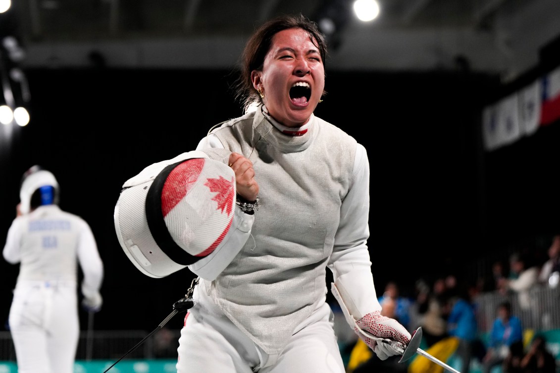 Team Canada fencing athlete Jessica Guo shouts in celebration