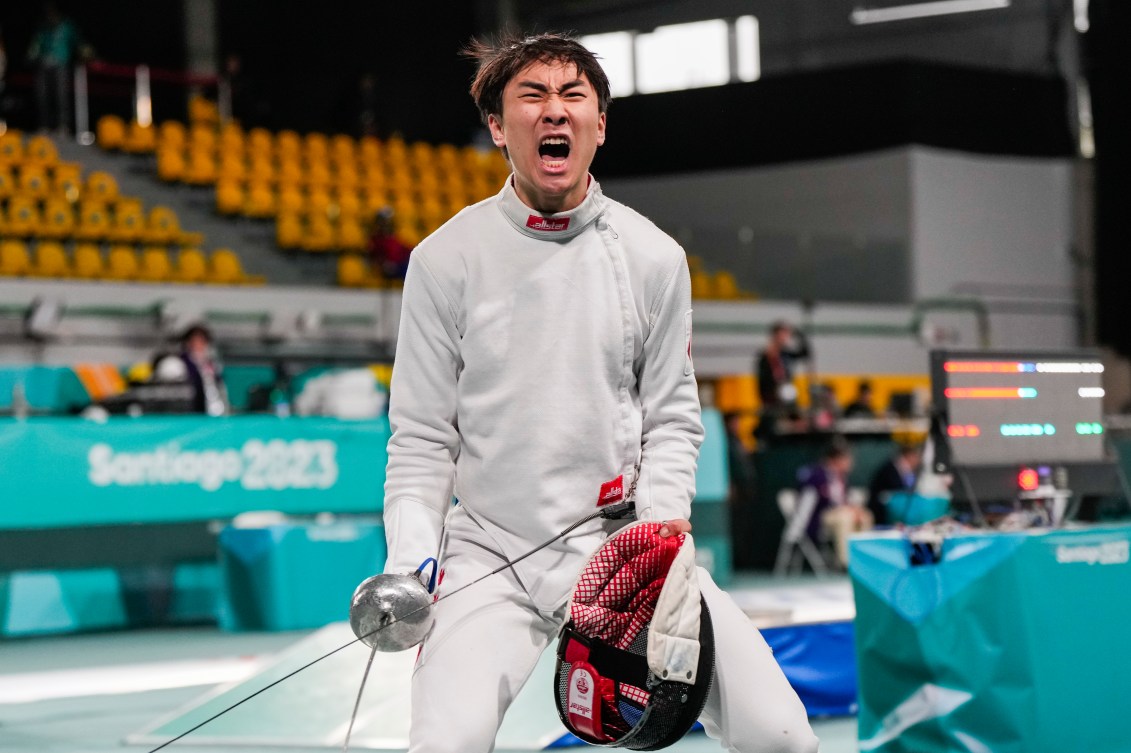 Canadian fencer Nicholas Zhang shouts in celebration