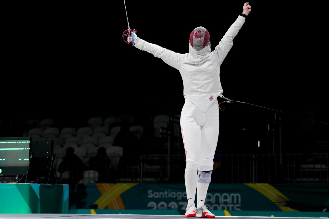 Canadian fencer Pamela Brind’Amour raises her arms in celebration