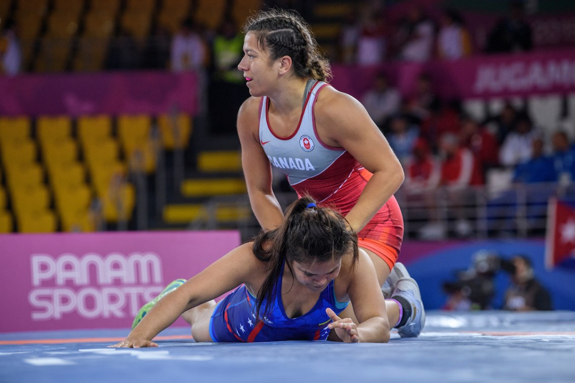 Justina Di Stasio pins her opponent to the mat in a wrestling match 
