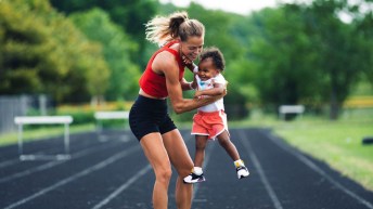 Melissa Bishop plays with her child on the track