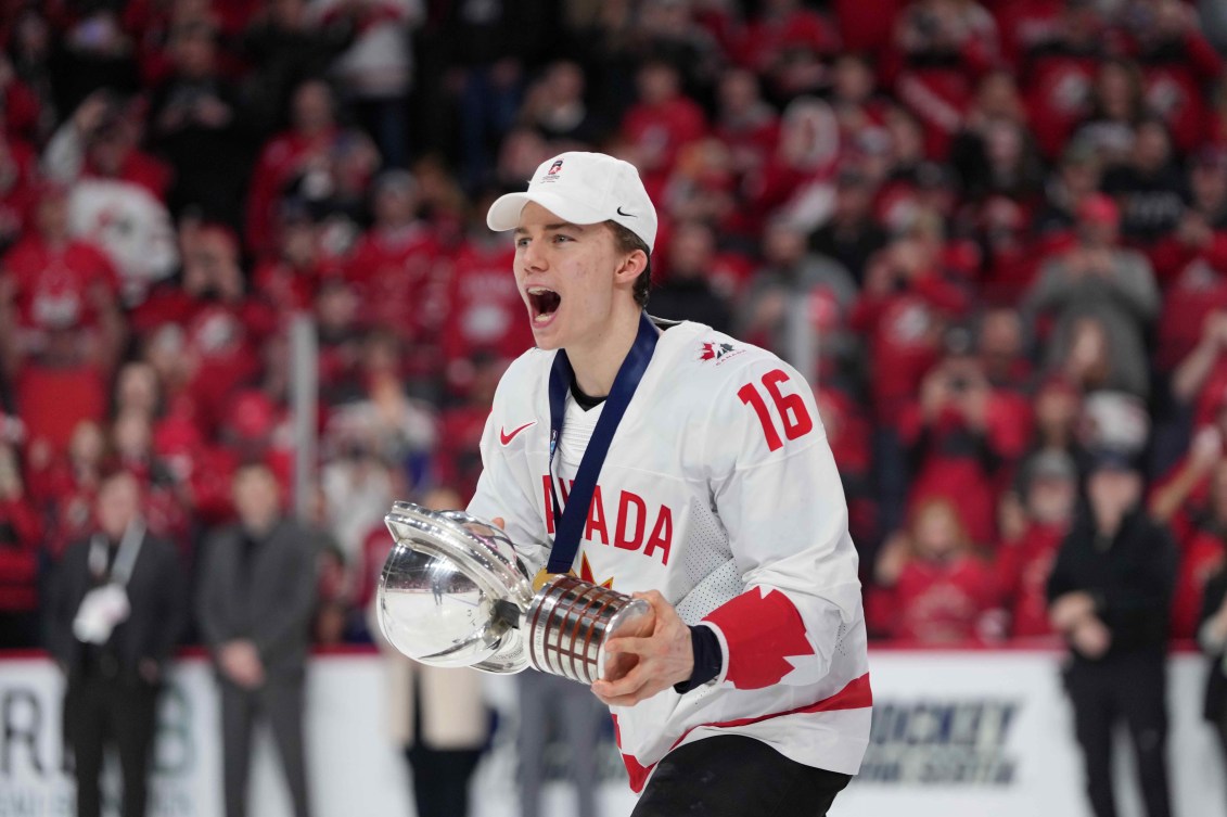 Canada's Connor Bedard carries the IIHF Championship Cup while celebrating winning over Czechia at the IIHF World Junior Hockey Championship gold medal game in Halifax on Thursday, January 5, 2023.