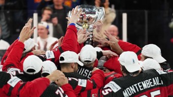 Canada hoists its trophy after defeating Germany to win the Ice Hockey World Championship.