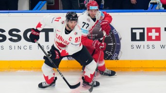Denmark's Mathias From, right, challenges Canada's John Tavares during the preliminary round match between Denmark and Canada at the Ice Hockey World Championships in Prague, Czech Republic, Sunday, May 12, 2024. (AP Photo/Petr David Josek)
