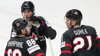 Canada's Dylan Cozens celebrates with teammates after scoring his sides first goal during the preliminary round match between Austria and Canada at the Ice Hockey World Championships in Prague, Czech Republic, Tuesday, May 14, 2024.