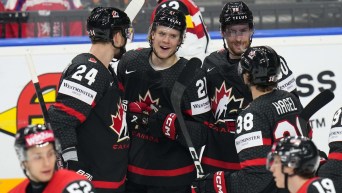 Canada's Kaiden Guhle celebrates with teammates after scoring his sides second goal during the preliminary round match between Austria and Canada at the Ice Hockey World Championships in Prague, Czech Republic, Tuesday, May 14, 2024.