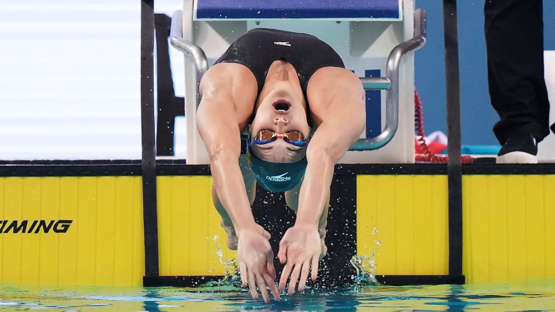 Kylie Masse dives backwards from the start into the pool