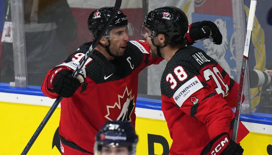 Canada's Brandon Hagel, right, celebrates with Canada's John Tavares after scoring his sides fourth goal during the preliminary round match between Canada and Finland at the Ice Hockey World Championships in Prague, Czech Republic, Saturday, May 18, 2024. (AP Photo/Petr David Josek)