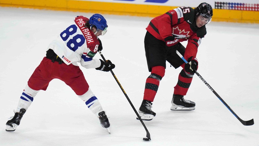 Canada's Owen Power challenges Czech Republic's David Pastrnak during the preliminary round match between Czech Republic and Canada at the Ice Hockey World Championships in Prague, Czech Republic, Tuesday, May 21, 2024.