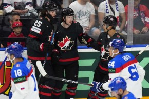 Canada's Jared McCann celebrates with teammates after scoring his sides first goal during the quarterfinal match between Canada and Slovakia at the Ice Hockey World Championships in Prague, Czech Republic, Thursday, May 23, 2024.