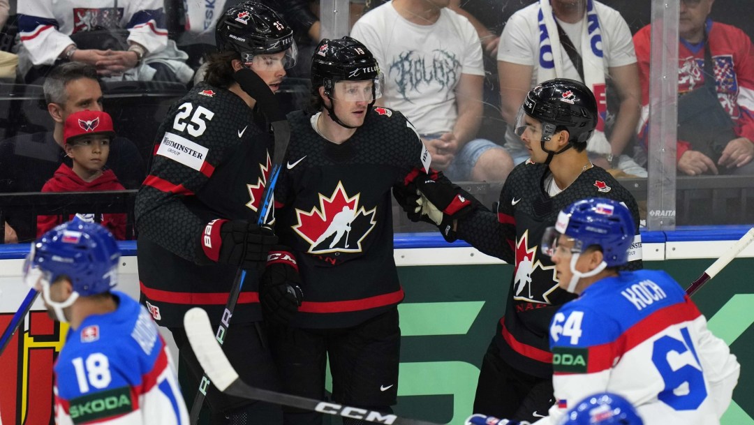 Canada's Jared McCann celebrates with teammates after scoring his sides first goal during the quarterfinal match between Canada and Slovakia at the Ice Hockey World Championships in Prague, Czech Republic, Thursday, May 23, 2024.