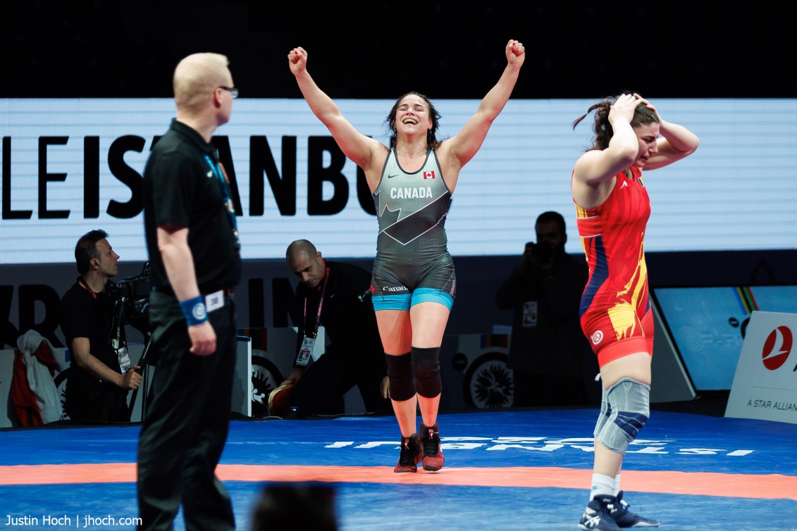 Linda Morais raises her arms above her head in celebration as her opponent reacts in anguish to losing the match 