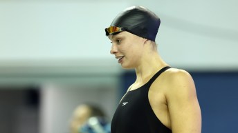 Penny Oleksiak prepares for a race in her swimsuit and swim cap