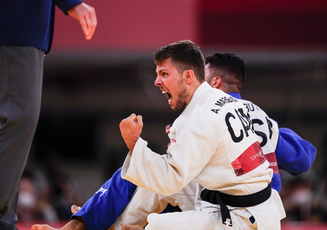 Judoka Arthur Margelidon pumps his fist in celebration