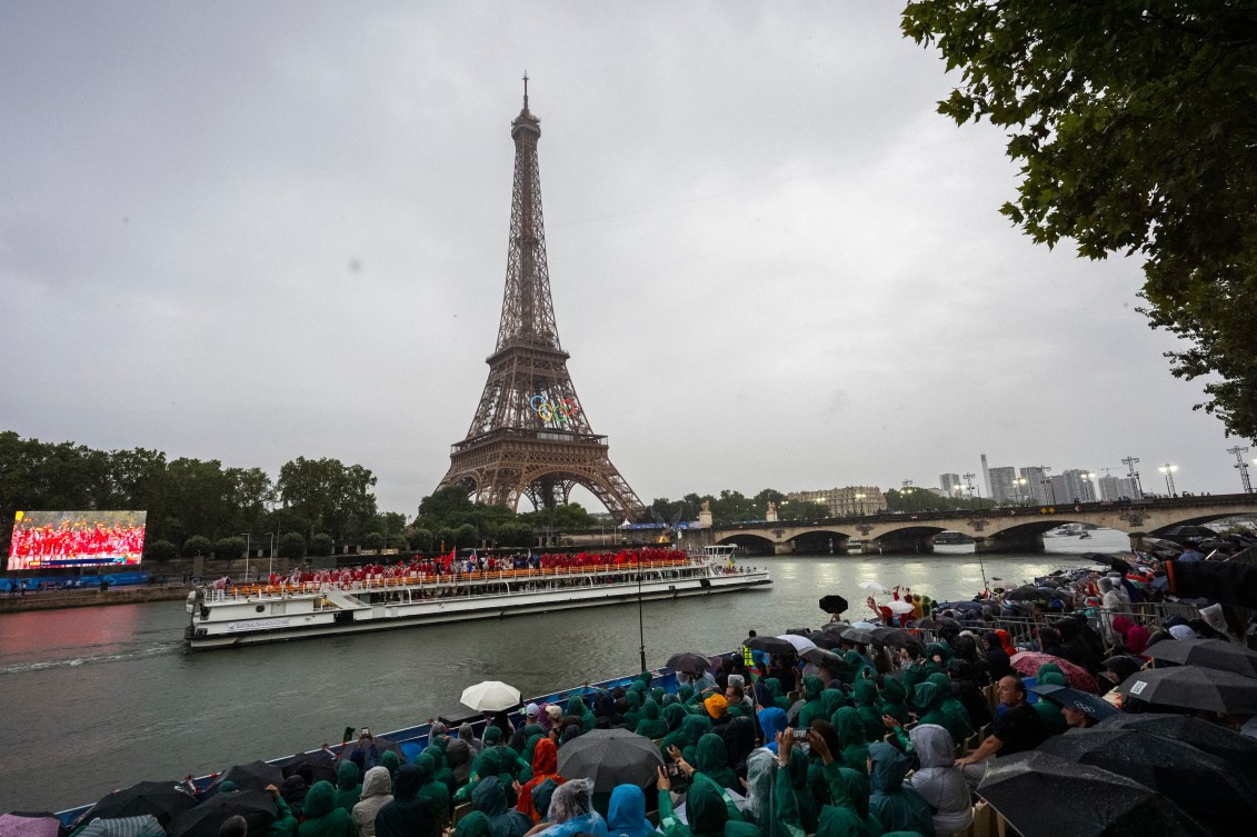 Team Canada passes the Eiffel Tower while cruising on the River Seine during the Opening Ceremony for Paris 2024.