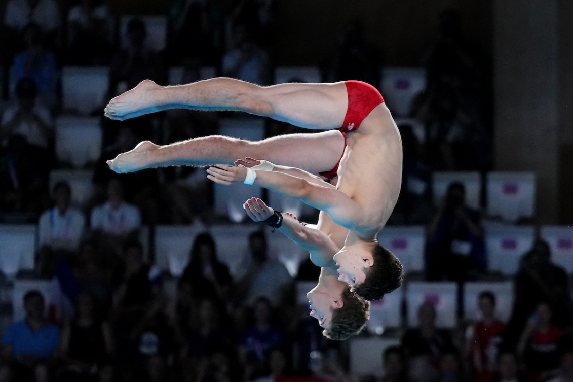 Two divers in an upside down pike