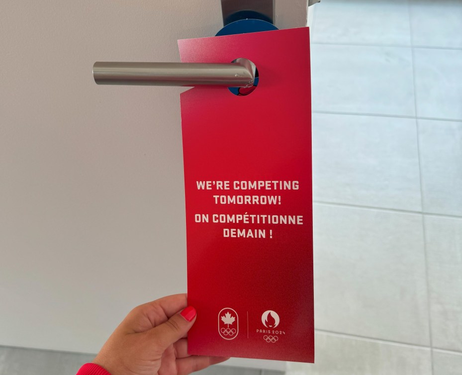 A red do not disturb sign reads: "We're competing tomorrow!"