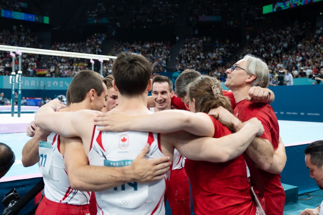 Team Canada's men's gymnastics team huddles together