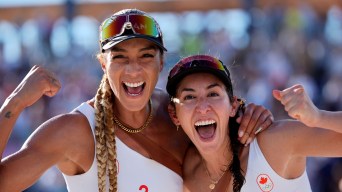 Brandie Wilkerson and Melissa Humana-Paredes yell at the camera and pump their arms in excitement