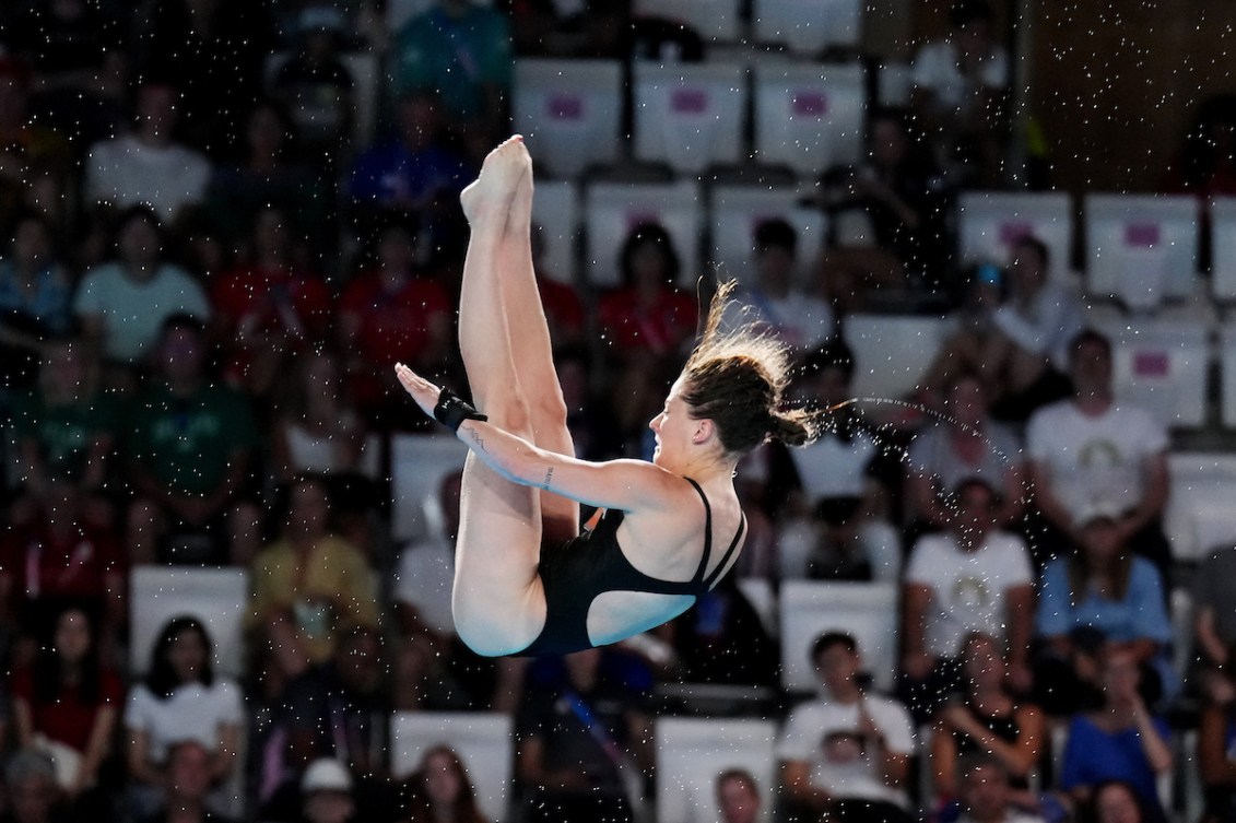 Caeli McKay dives into the pool
