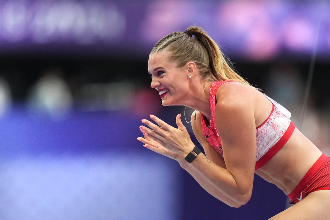 Alysha Newman claps her hands and grins in happiness