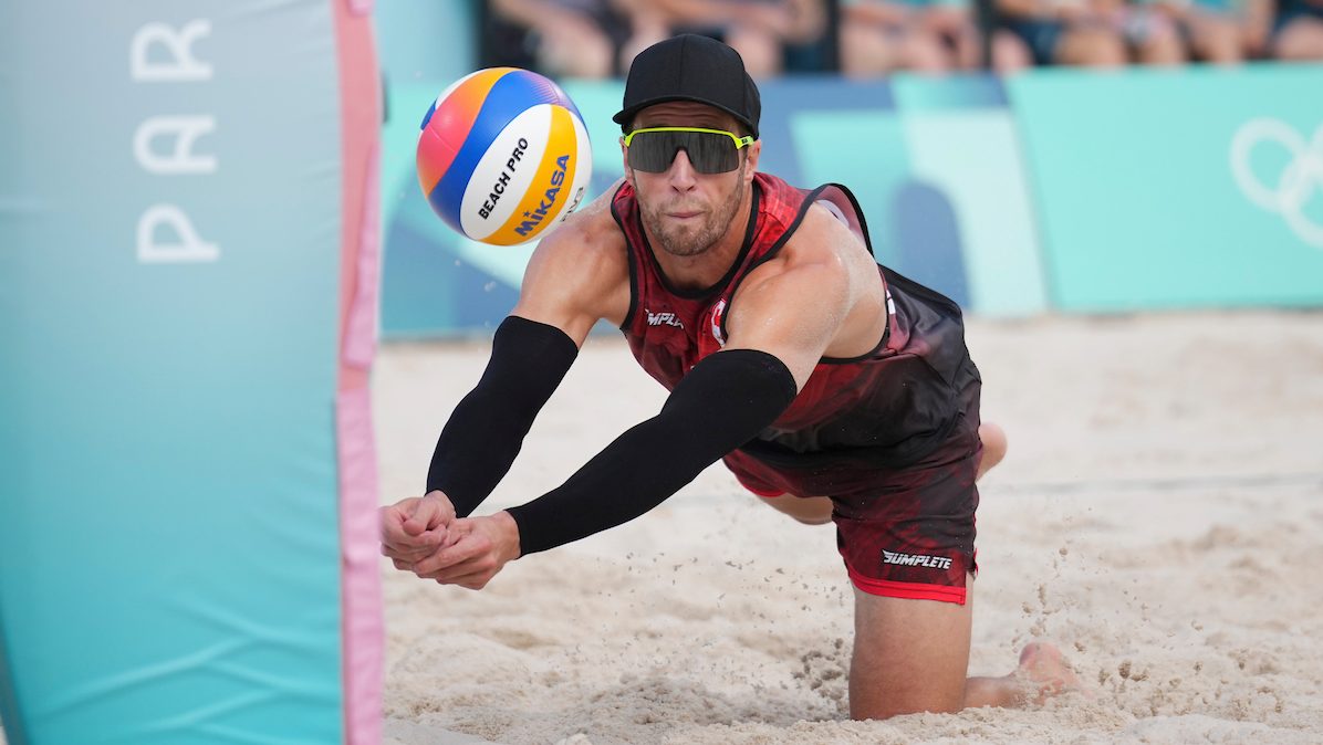 Samuel Schachter digs a ball against Czech Republic in beach volleyball 