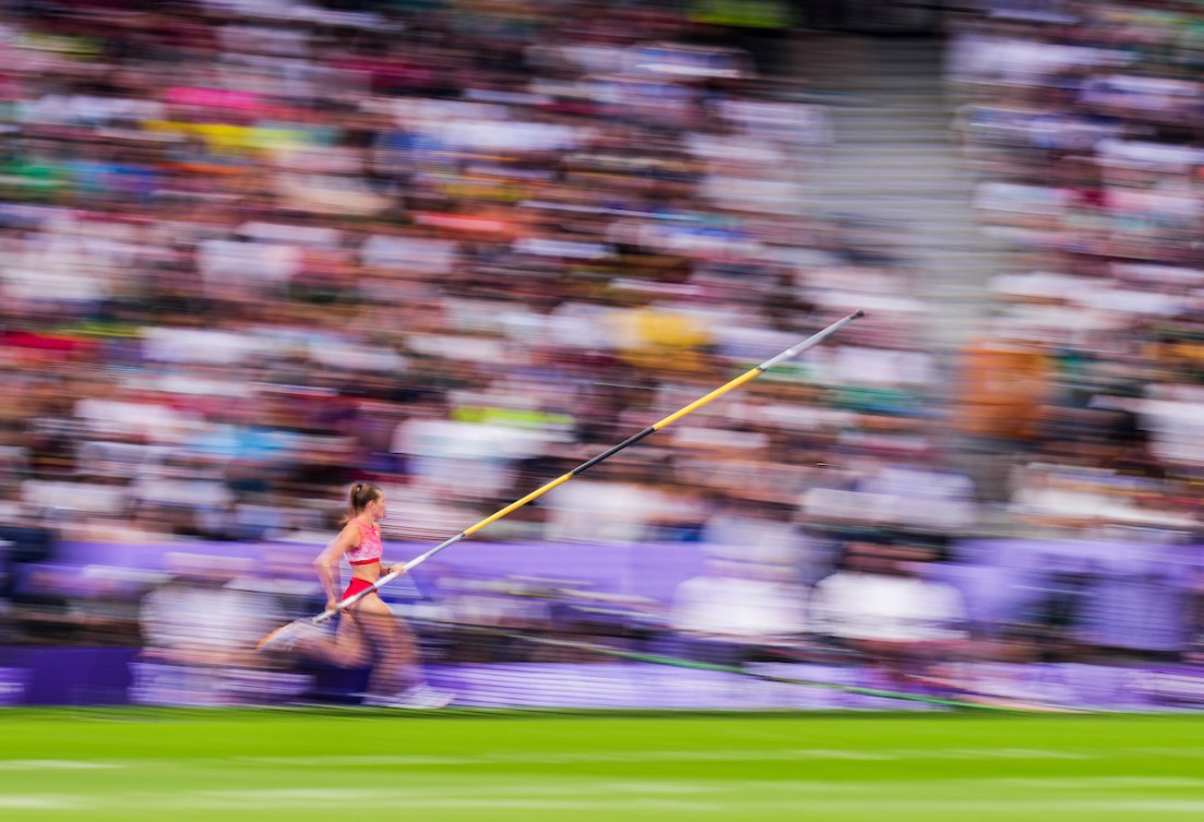 A blurred shot of Alysha Newman running with her pole vault