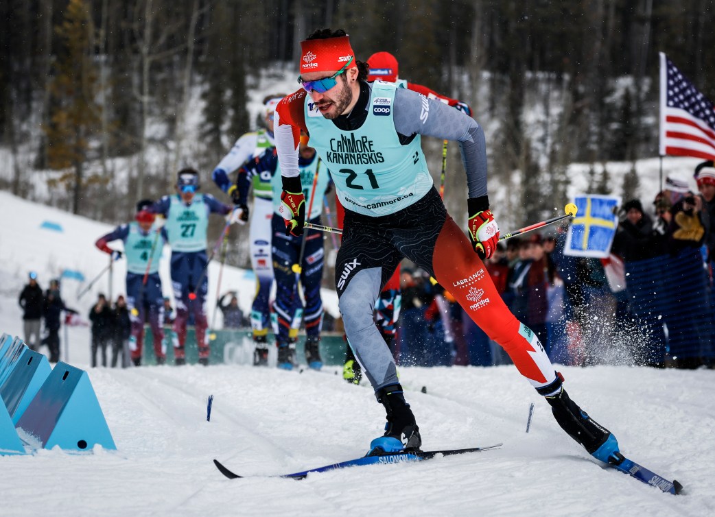 Antoine Cyr skis with skate technique while wearing a baby blue singlet