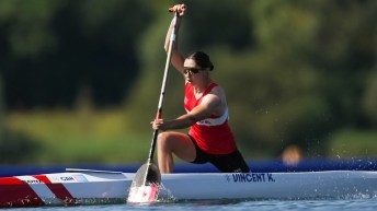 Katie Vincent paddles her canoe while wearing a red Team Canada singlet