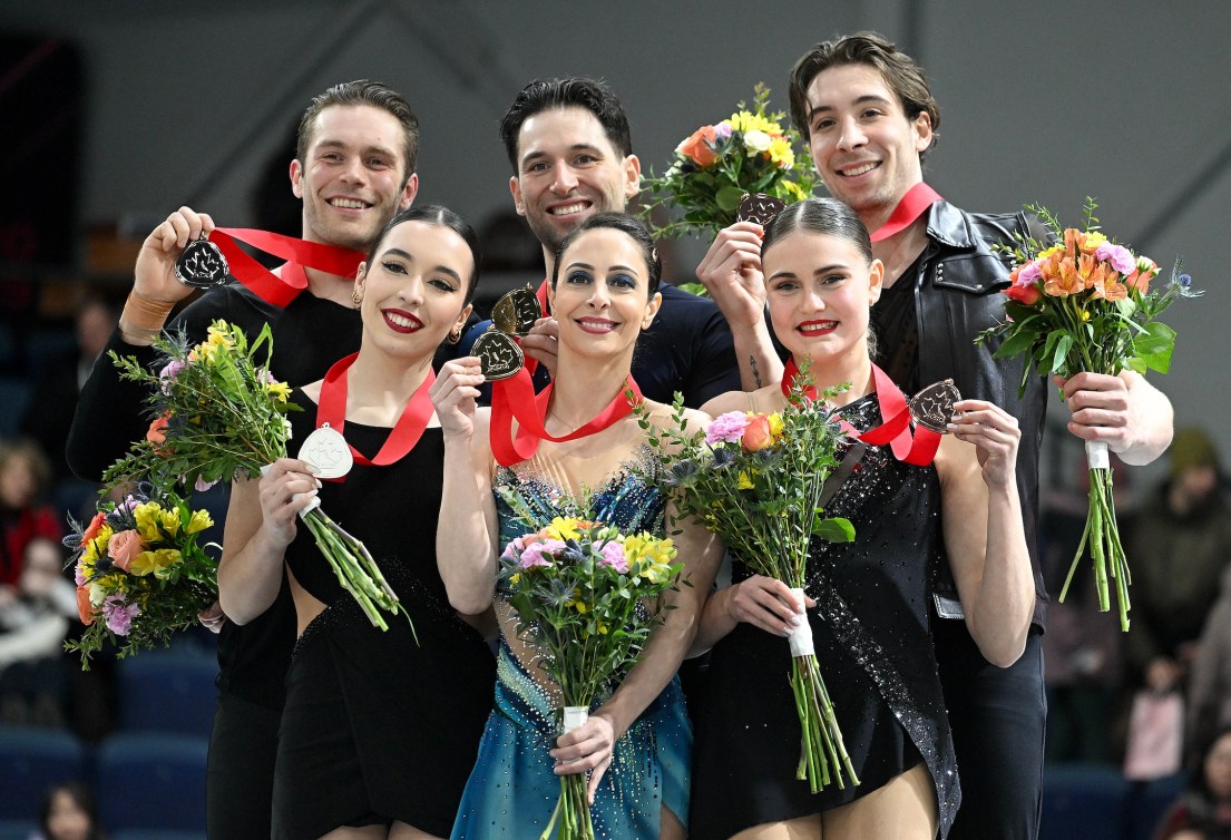 Gold medalists Deanna Stellato-Dudek and Maxime Deschamps, centre, bronze medalists Kelly Ann Laurin and Loucas Ethier, right, and silver medalists Lia Pereira and Trennt Michaud hold up their medals following the pair's competition at the Canadian National Skating Championships in Laval, Que., Saturday, January 18, 2025.