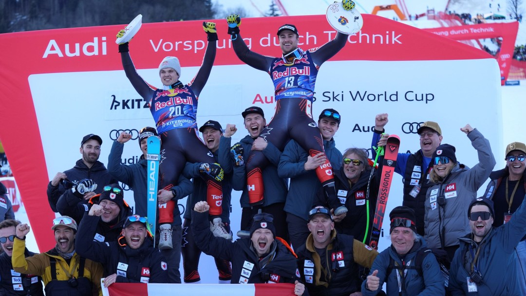 Jack Crawford and Cam Alexander sit on the shoulders of teammates in the podium area at a World Cup