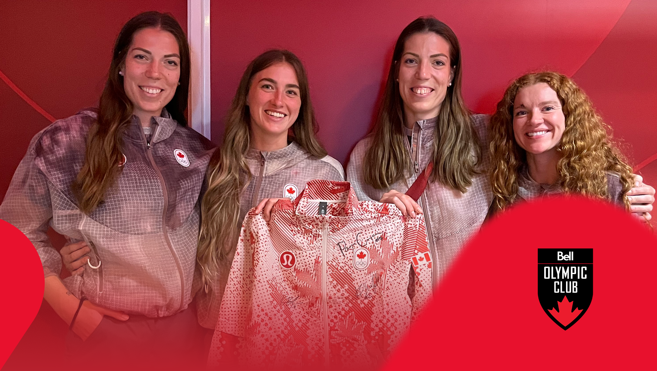 four athletes holding a signed jacket