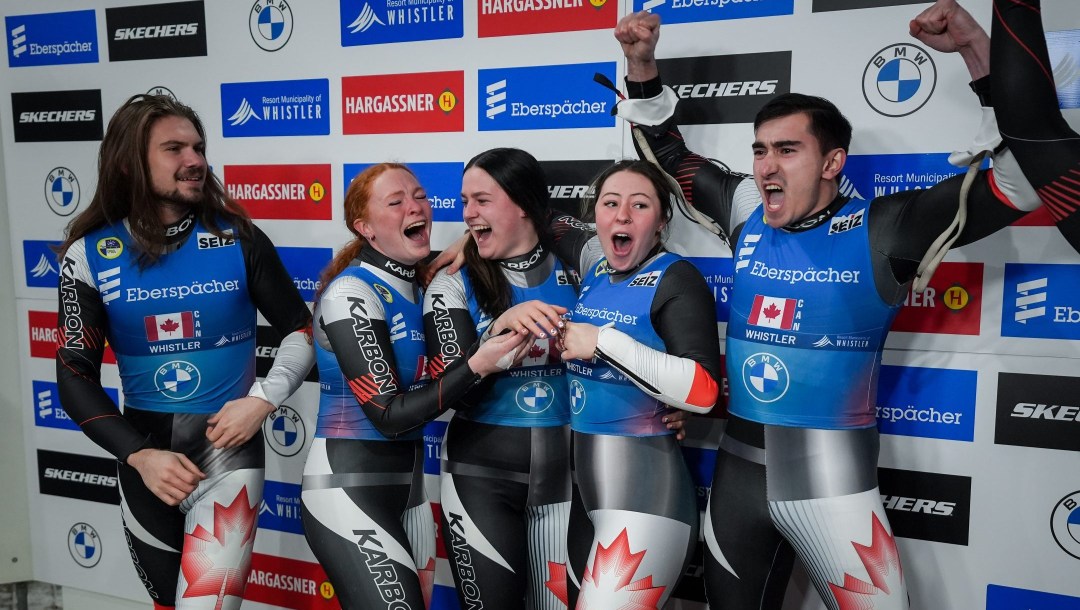 Canadians Theo Downey, from left, Kailey Allan, Embyr-Lee Susko, Beattie Podulsky and Devin Wardrope celebrate after earning a third place in the team relay event at the World Luge Championships, in Whistler, British Columbia, Saturday, February 8, 2025.