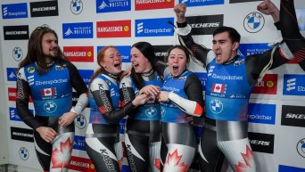 Canadians Theo Downey, from left, Kailey Allan, Embyr-Lee Susko, Beattie Podulsky and Devin Wardrope celebrate after earning a third place in the team relay event at the World Luge Championships, in Whistler, British Columbia, Saturday, February 8, 2025.