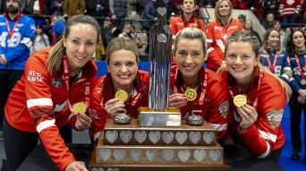 Team Homan poses with their medals and trophy at the Tournament of Hearts