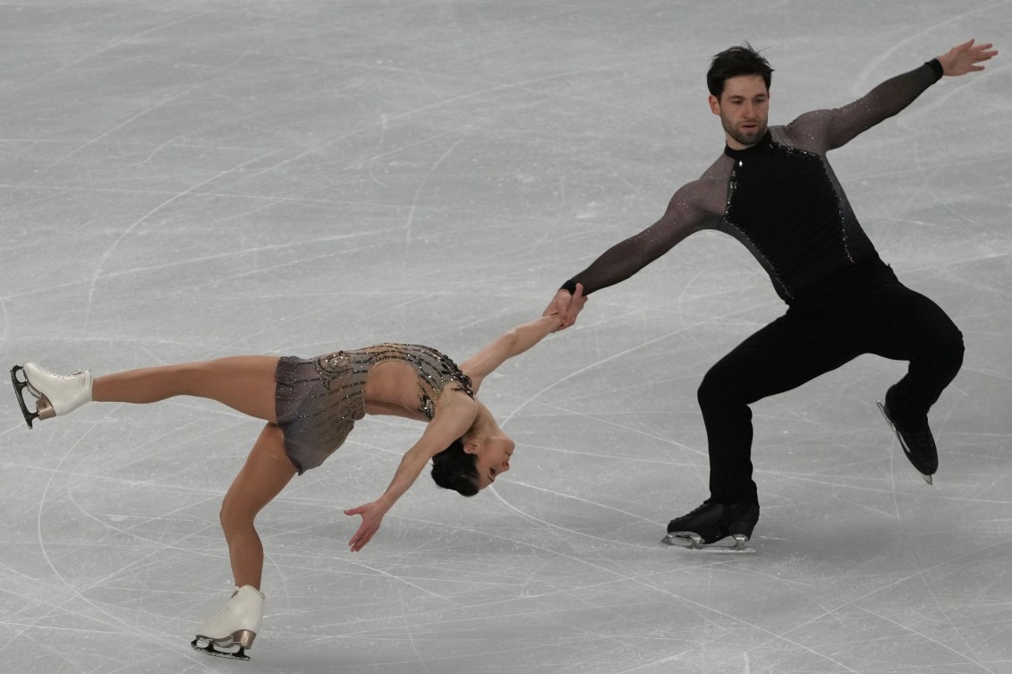 Deanna Stellato-Dudek and Maxime Deschamps perform a death spiral in their figure skating program