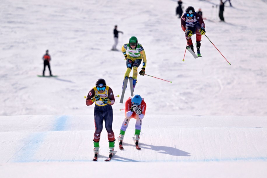 Four ski cross racers cross the finish line
