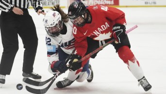 United States' Kelly Pannek, left, challenges Blayre Turnbull of Canada during the group A match between United States and Canada at the Women's Ice Hockey Championships in Ceske Budejovice, Czech Republic, Sunday, April 13, 2025. (AP Photo/Petr David Josek)