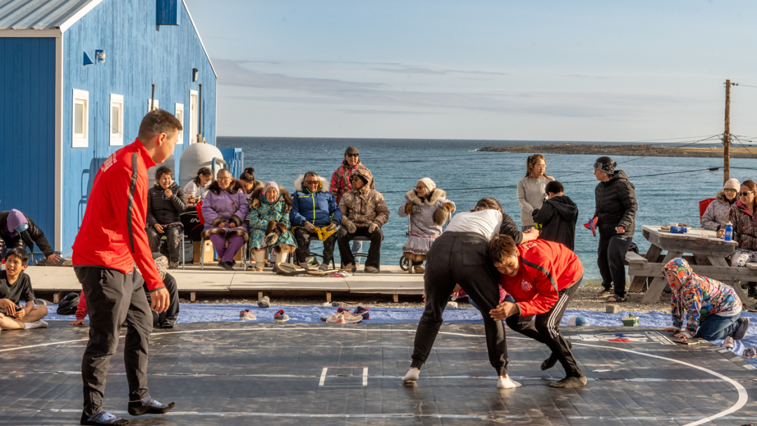Youth wrestlers practice in front of a waterfront