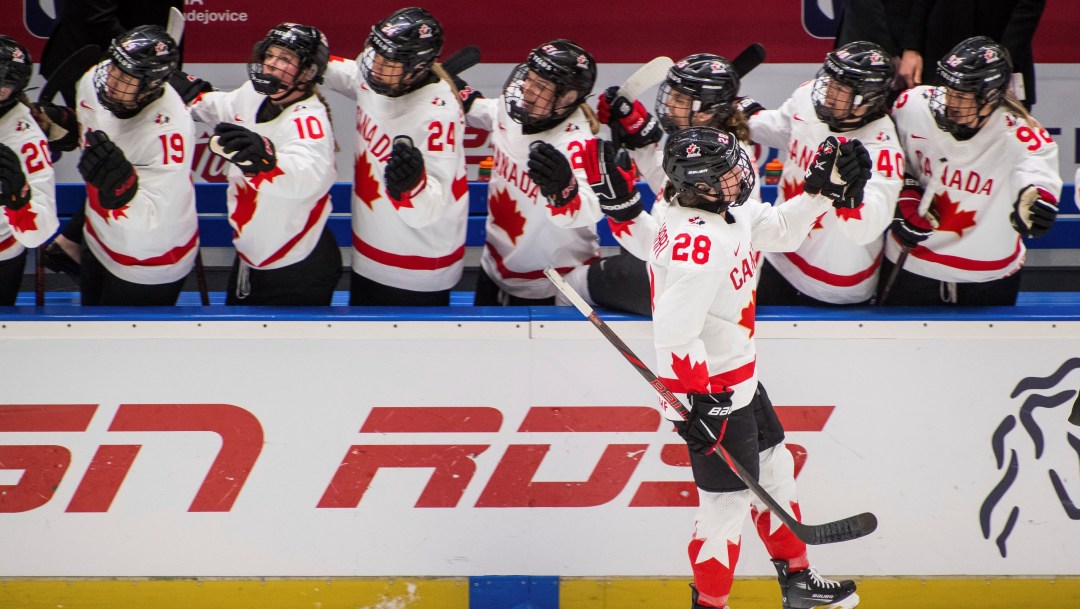 Canada's Micah Zandee-Hart high fives her teammates along the bench as she celebrates scoring during the IIHF Women's World Championship, Group A, match between Switzerland and Canada, in Ceske Budejovice, Czech Republic, Friday, April 11, 2025.