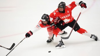 Renata Fast of Canada, right, challenges Japan's Rui Ukita during the quarterfinal match between Canada and Japan at the Women's Ice Hockey Championships in Ceske Budejovice, Czech Republic, Thursday, April 17, 2025.