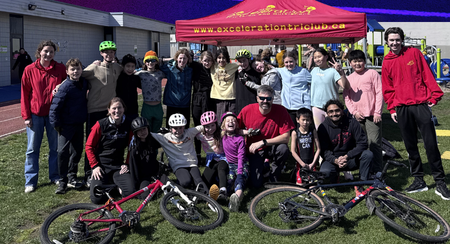 A group of youth poses with bikes outside