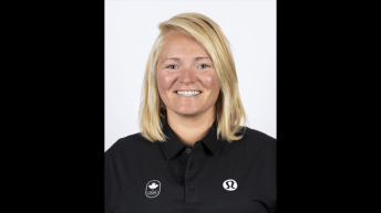 headshot - woman with blonde hair wearing black polo shirt smiles at camera