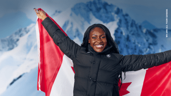 Cynthia Appiah holds a Canadian flag behind her back and smiles