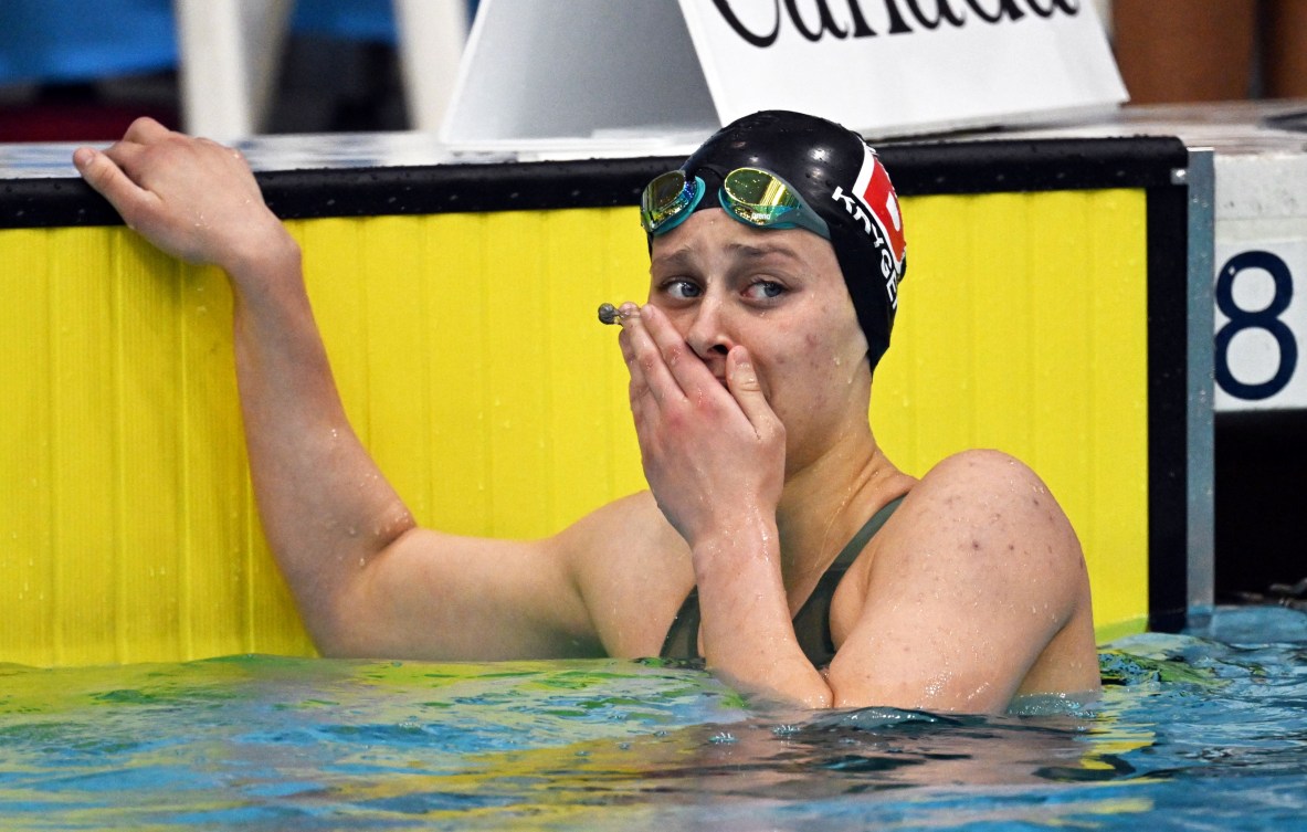 Madison Kryger holds her hand to her face as she reacts with happy tears