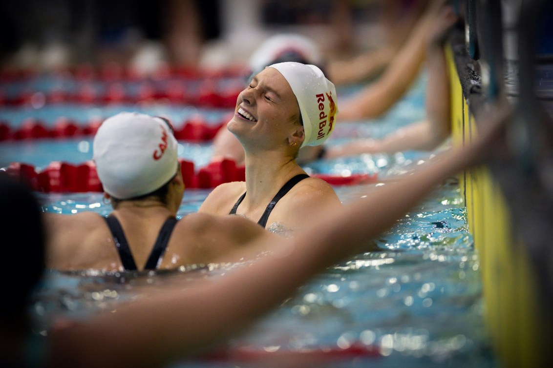 Summer McIntosh tosses her head back in relief at the end of the pool