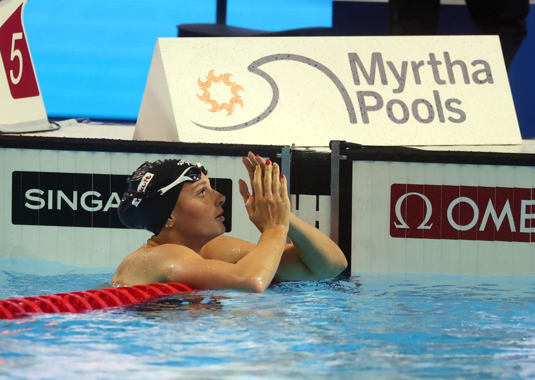 Summer McIntosh leans on the lane rope
